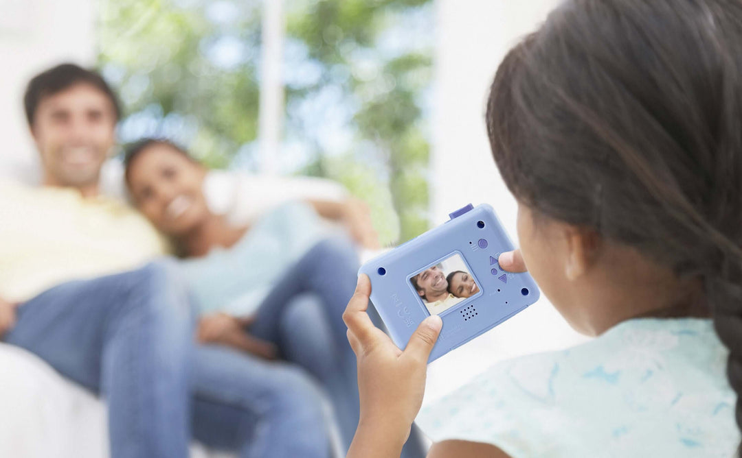 Child using Disney Frozen digital camera to take photo of parents