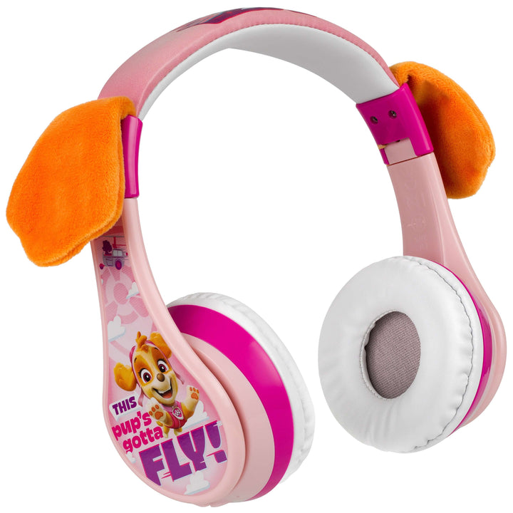 Paw Patrol Skye Bluetooth headphones with orange ears, pink and purple design, and "This pup's gotta fly" text for kids