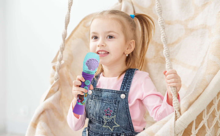 Little girl enjoying Ariel Karaoke Microphone Toy for Kids with Disney-themed graphics